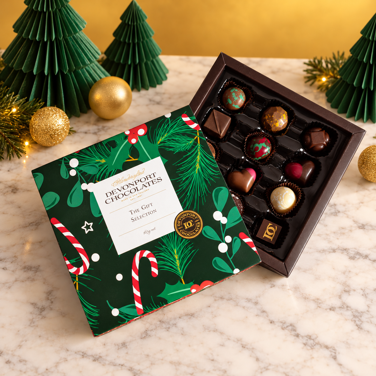 A Special Christmas 12-piece bonbon gift box with festive green packaging on a marble surface